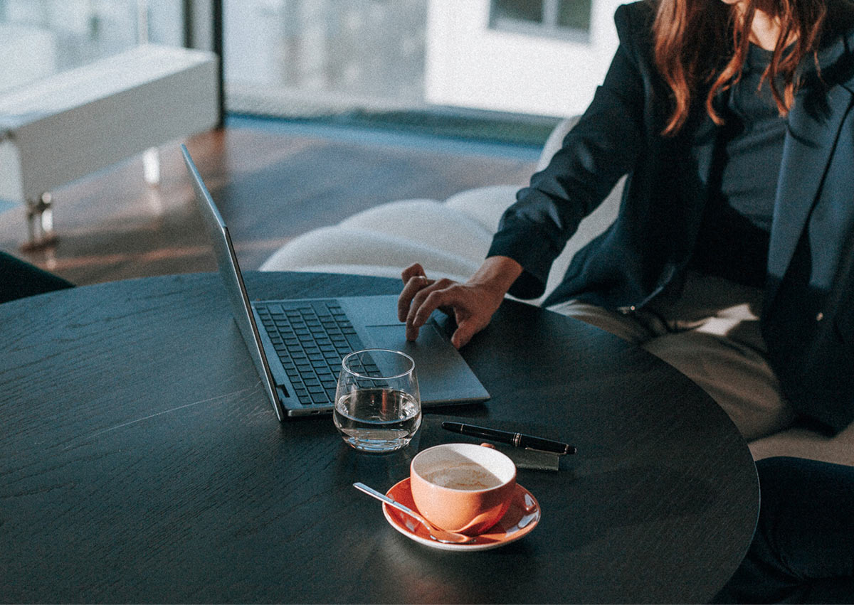 Arbeitsplatz mit Laptop und Kaffee bei alevate